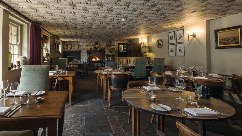 Dining room with fireplace at The White Swan Inn, Pickering